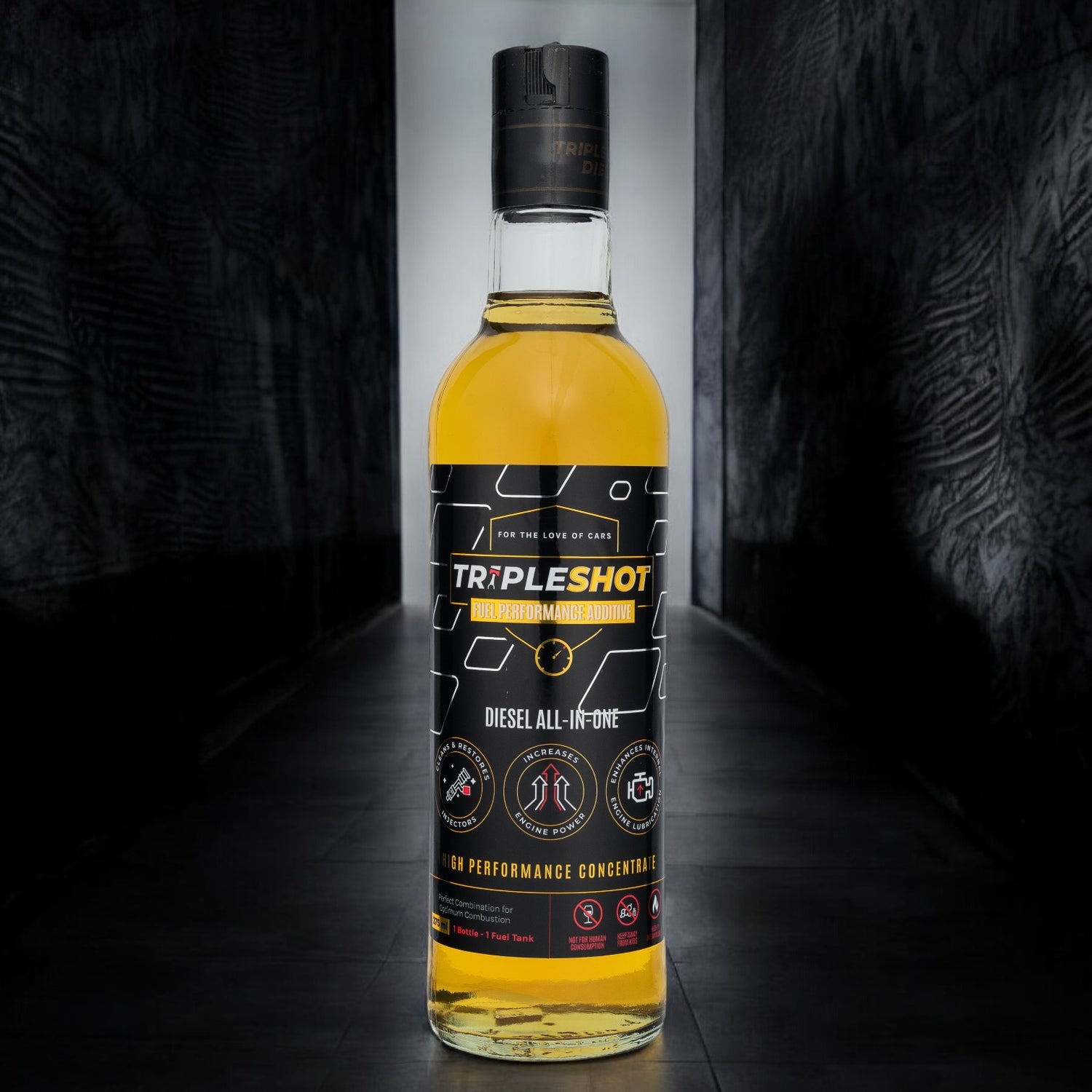 Bottle of Tripleshot diesel fuel additive on a dark background.