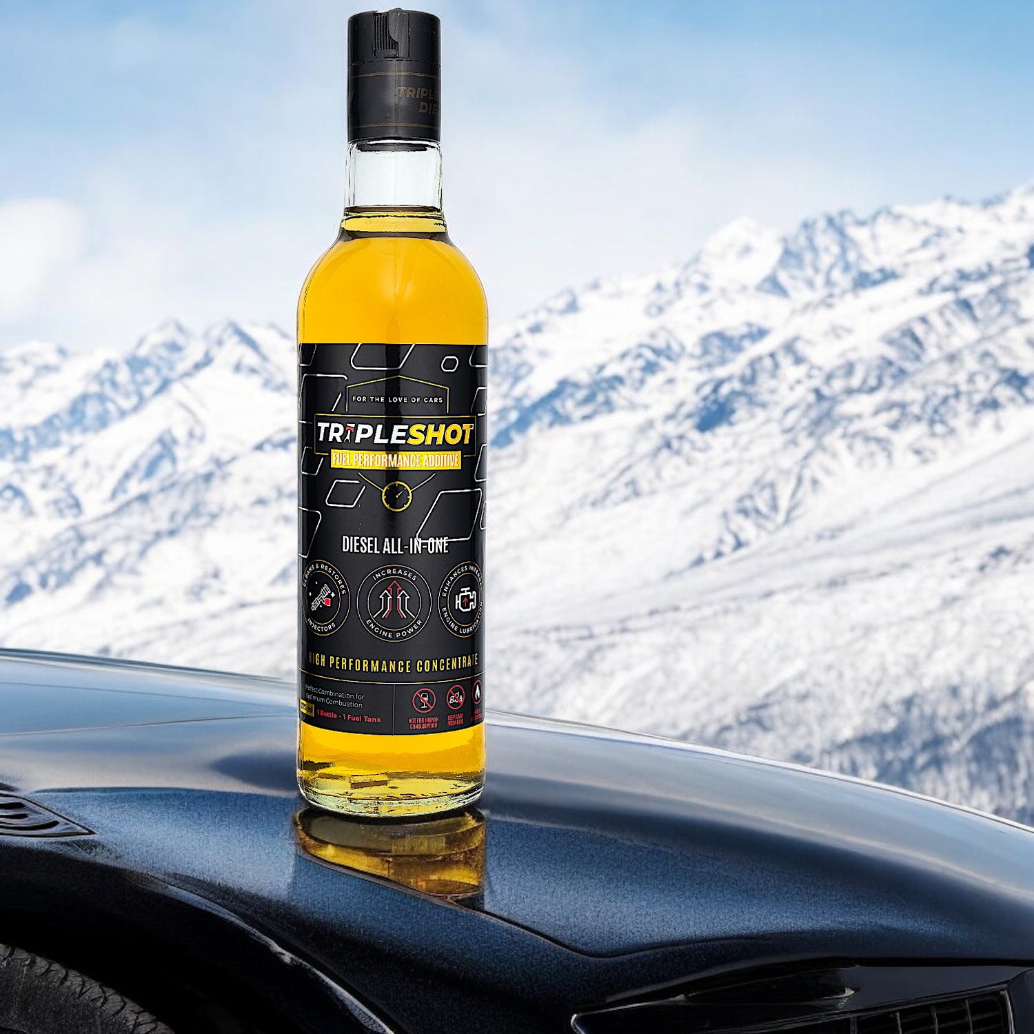Bottle of Tripleshot diesel treatment on a car hood with snowy mountains in the background.