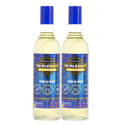 Two bottles of Tripleshot Petrol All-in-One Fuel Performance Additive placed side by side on a white background. The blue-labeled bottles highlight benefits such as injector cleaning, increased engine power, and improved fuel combustion. Each bottle is a high-performance concentrate designed for petrol engines.